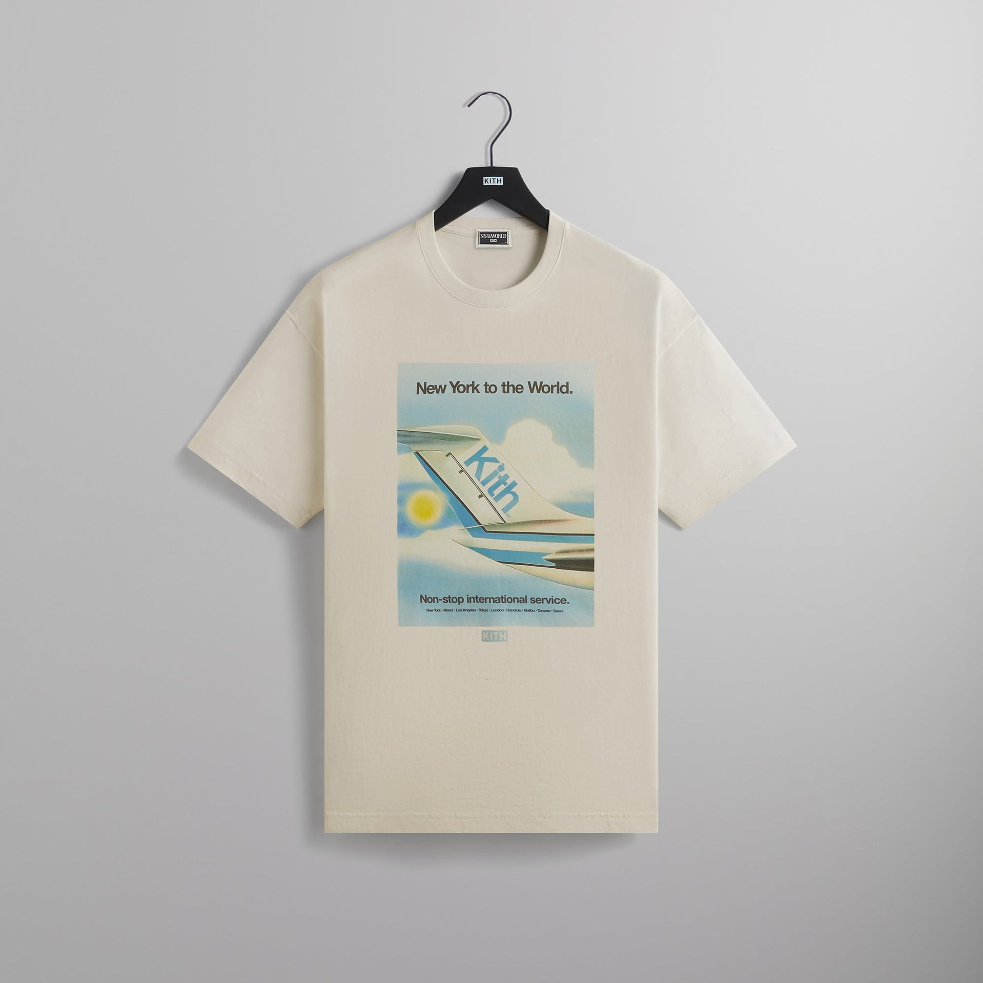 Kith NY to the World Int. Service Airline Tee - Sandrift