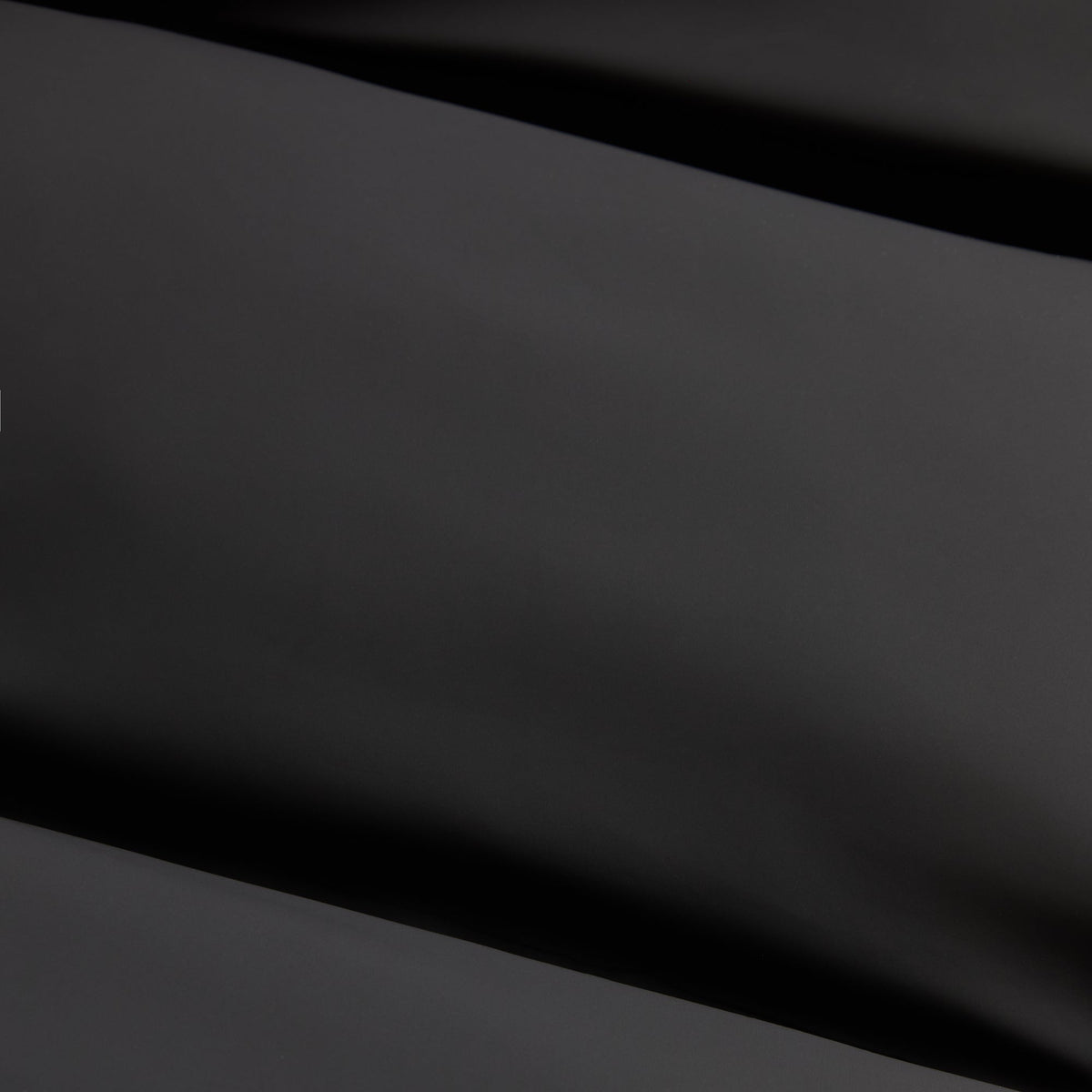Close-up of black stretch poly fabric of the Kith Filmore puffer