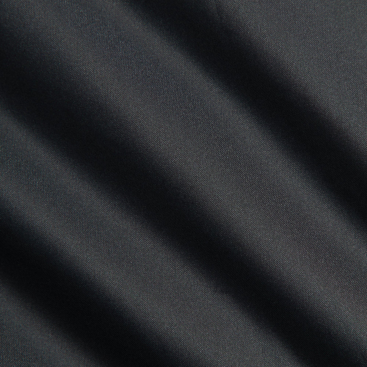 Close-up of black matte taffeta fabric of the Kith Corey puffer