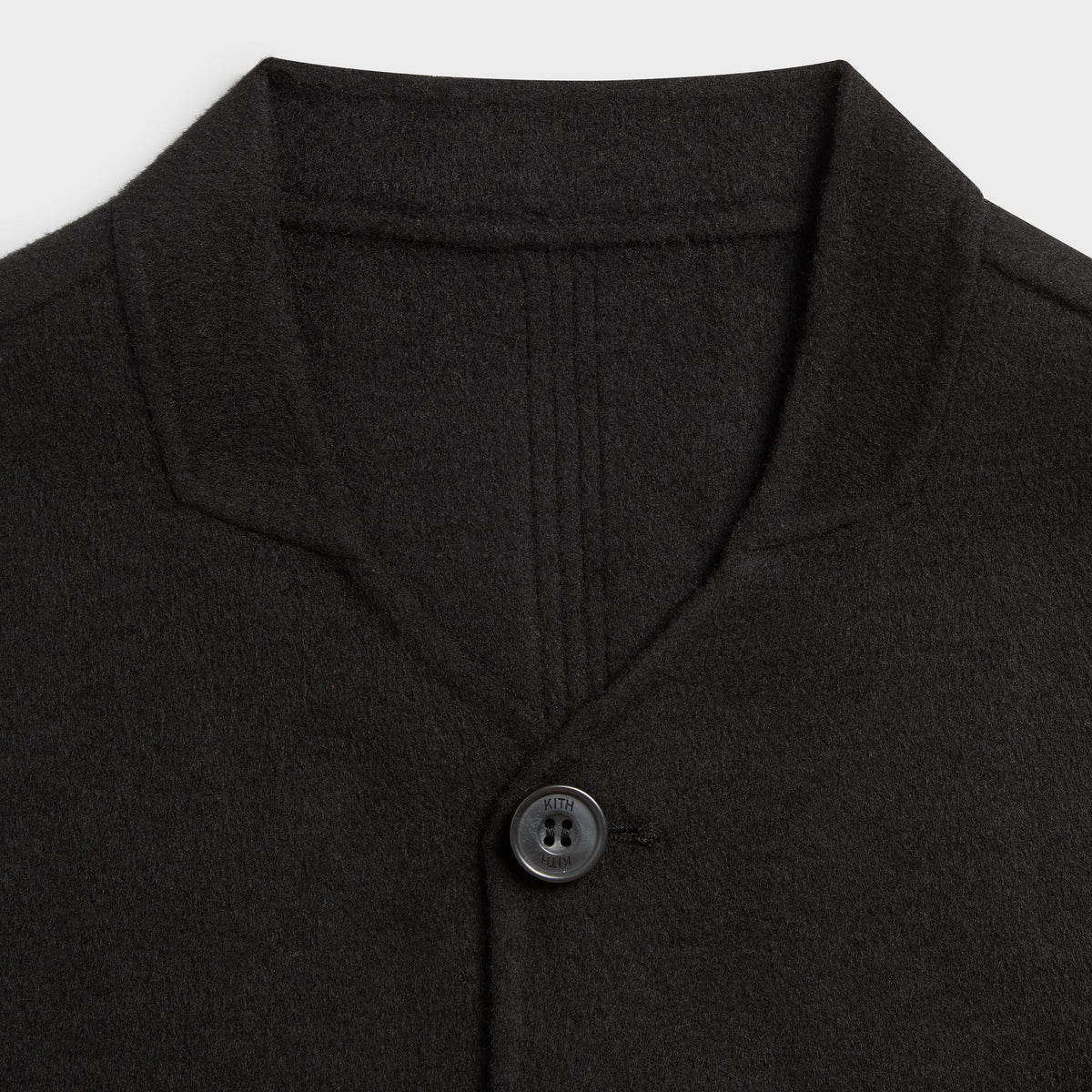 Close-up of the collar and top button on the black Double-Face Wool Wes jacket