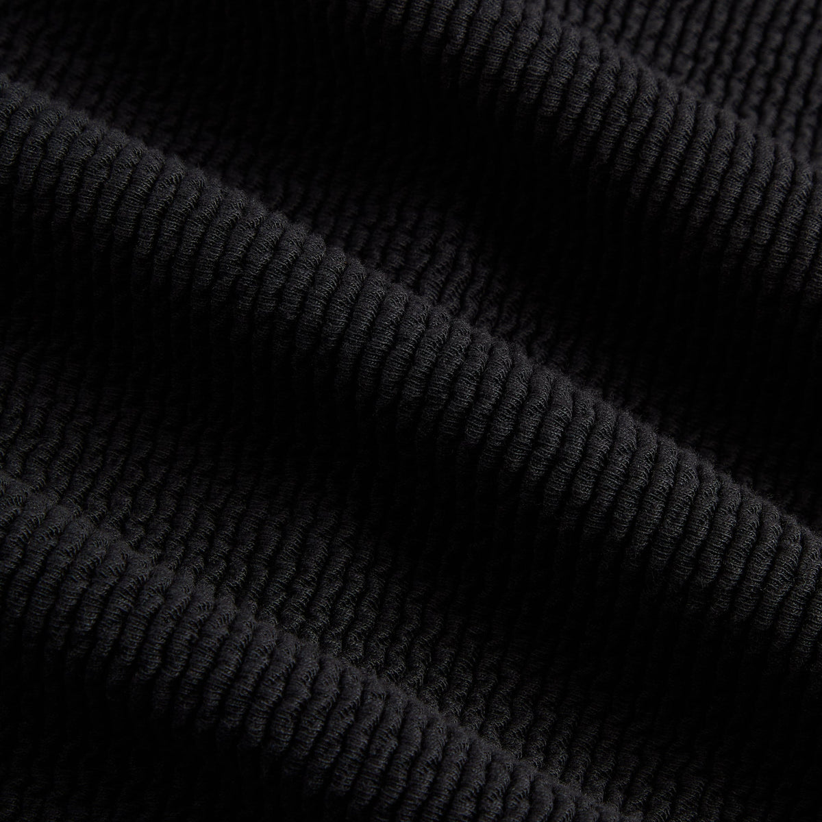 Close-up of black heavy crepe fabric of the Kith Wilder quarter-zip hoodie