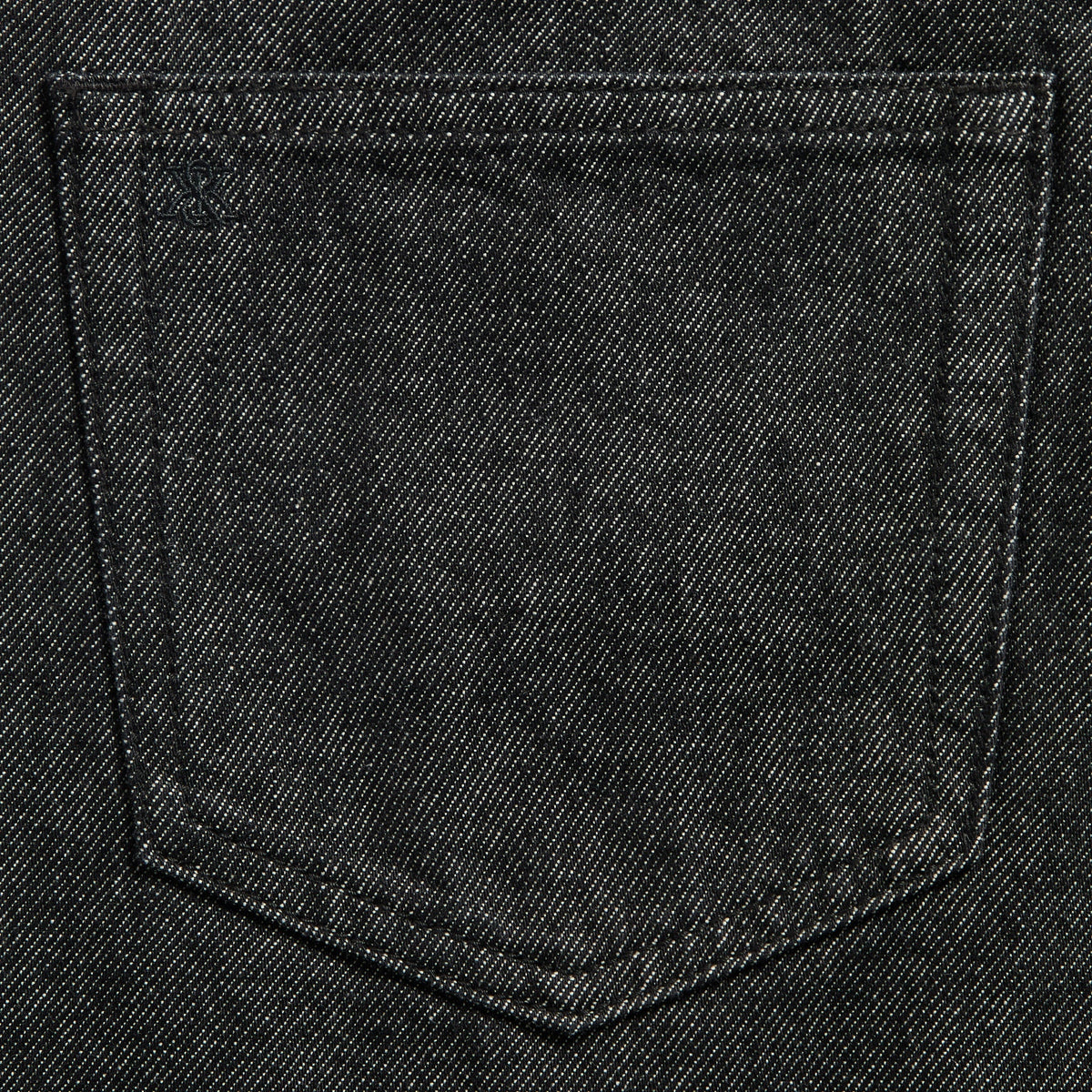 Close-up of the back pocket with tonal stitched logo on the Webster Chill jeans